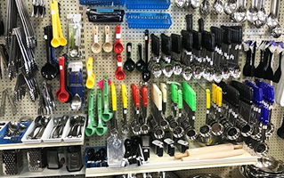 A shelf full of small kitchenware items at Skelton's Inc. Foodservice Equipment